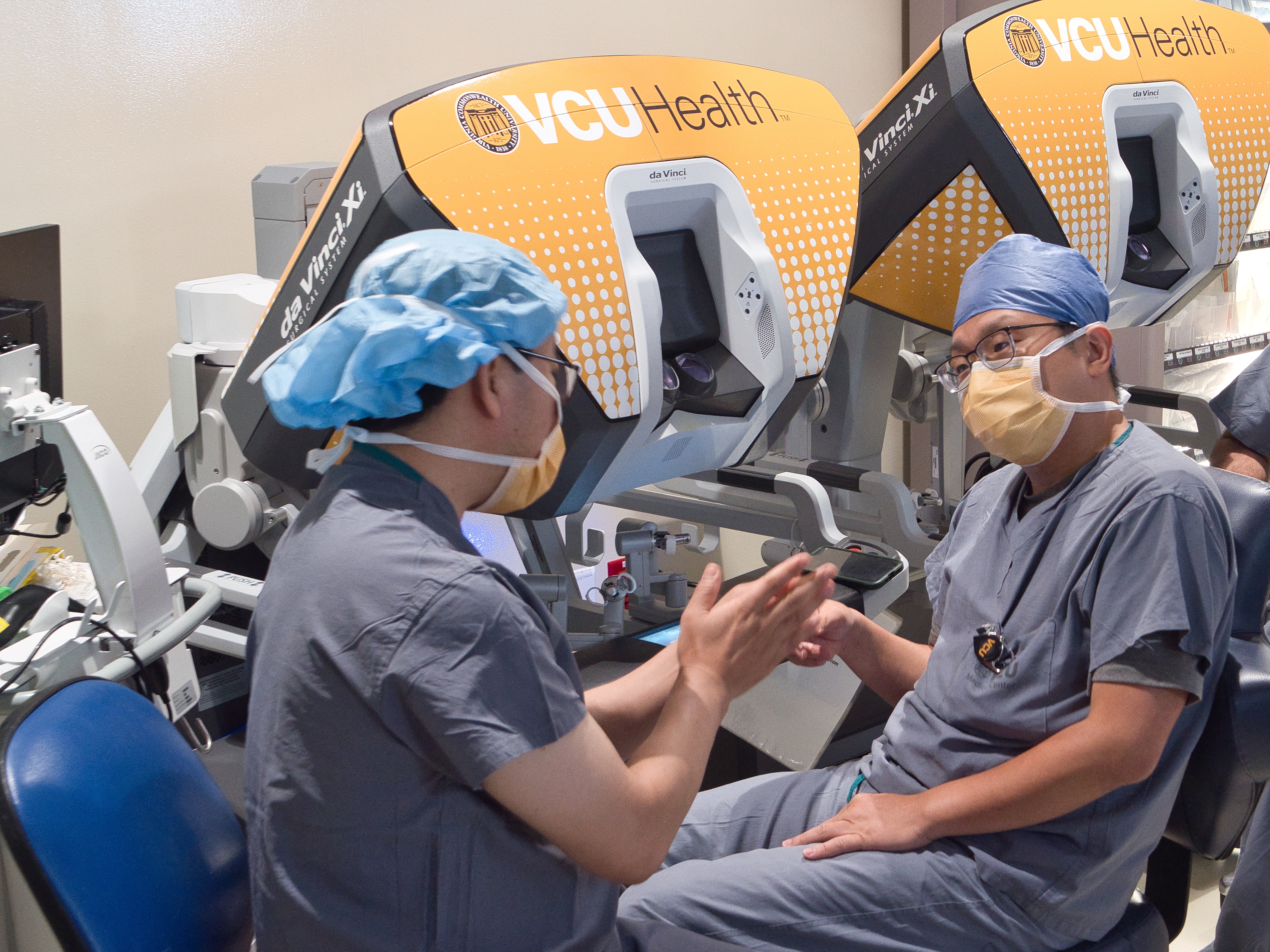 파란색 스크럽에 남성 2 명이 이야기합니다.